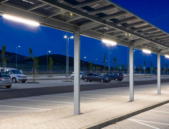 Parking area with cars parked, highlighting the safety and visibility benefits of parking lighting installation.
