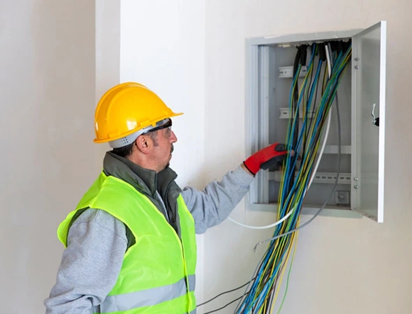 Technician expertly wiring residential LED lighting, ensuring safe and efficient installation for a modern home setup.